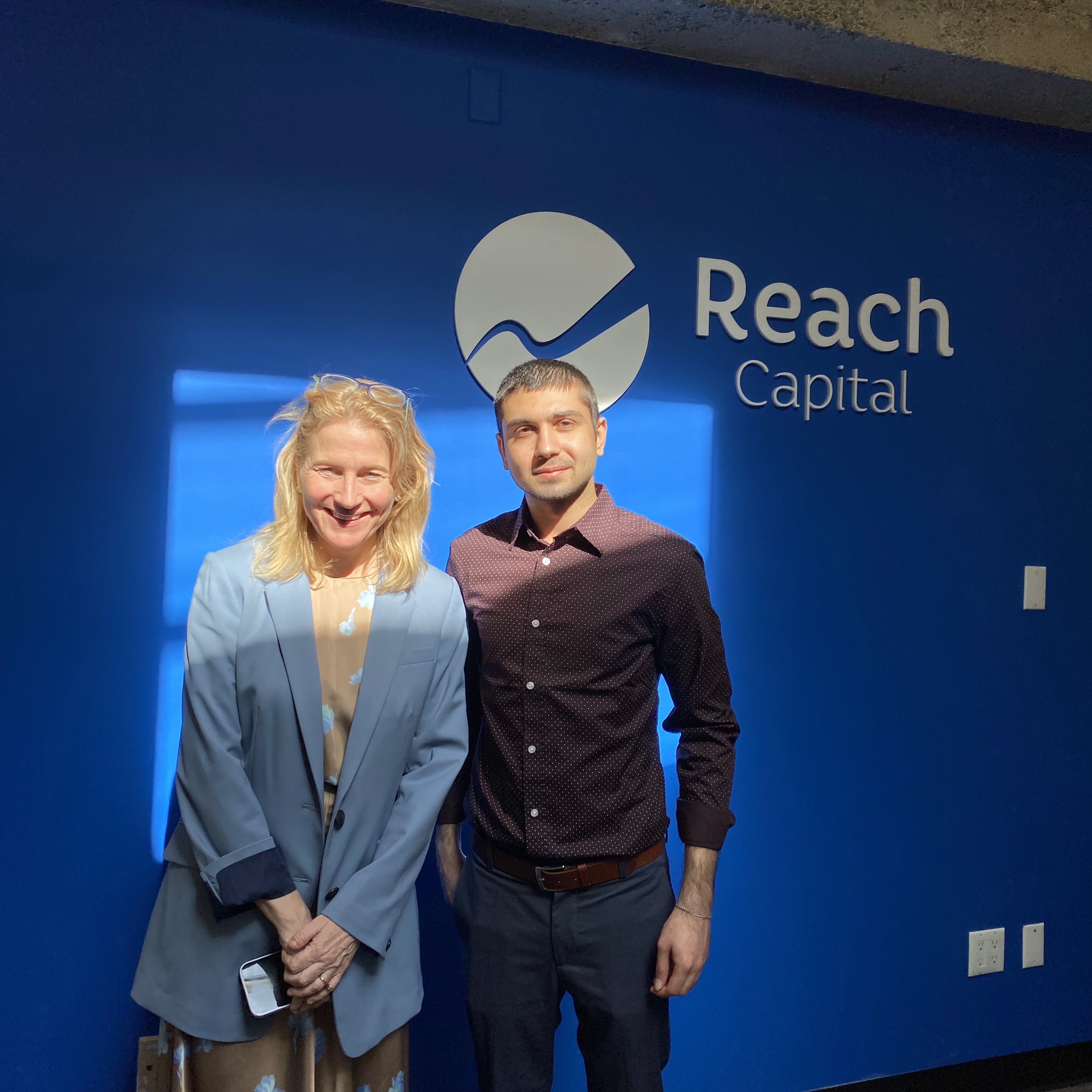 Student Fahad Shahbaz poses for a photo with alumna Jennifer Carolan at Reach Capital in San Francisco.